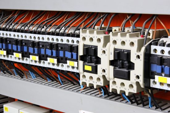 Neatly arranged cables in electrical control panel.