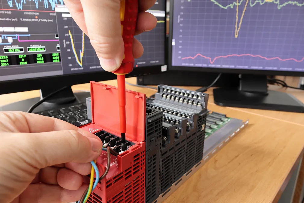 Engineer attaching wires to a component.